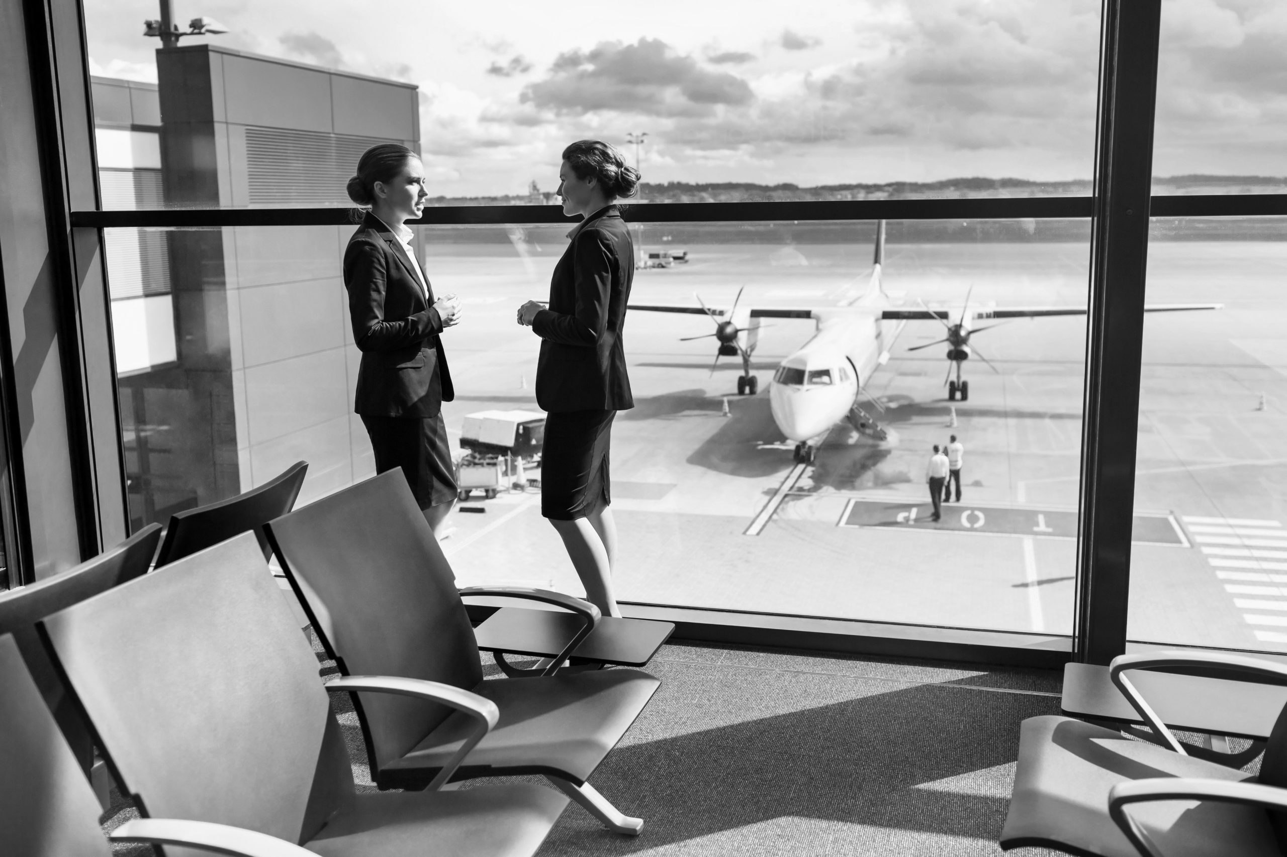 Picture of inside an airport looking out onto the runway