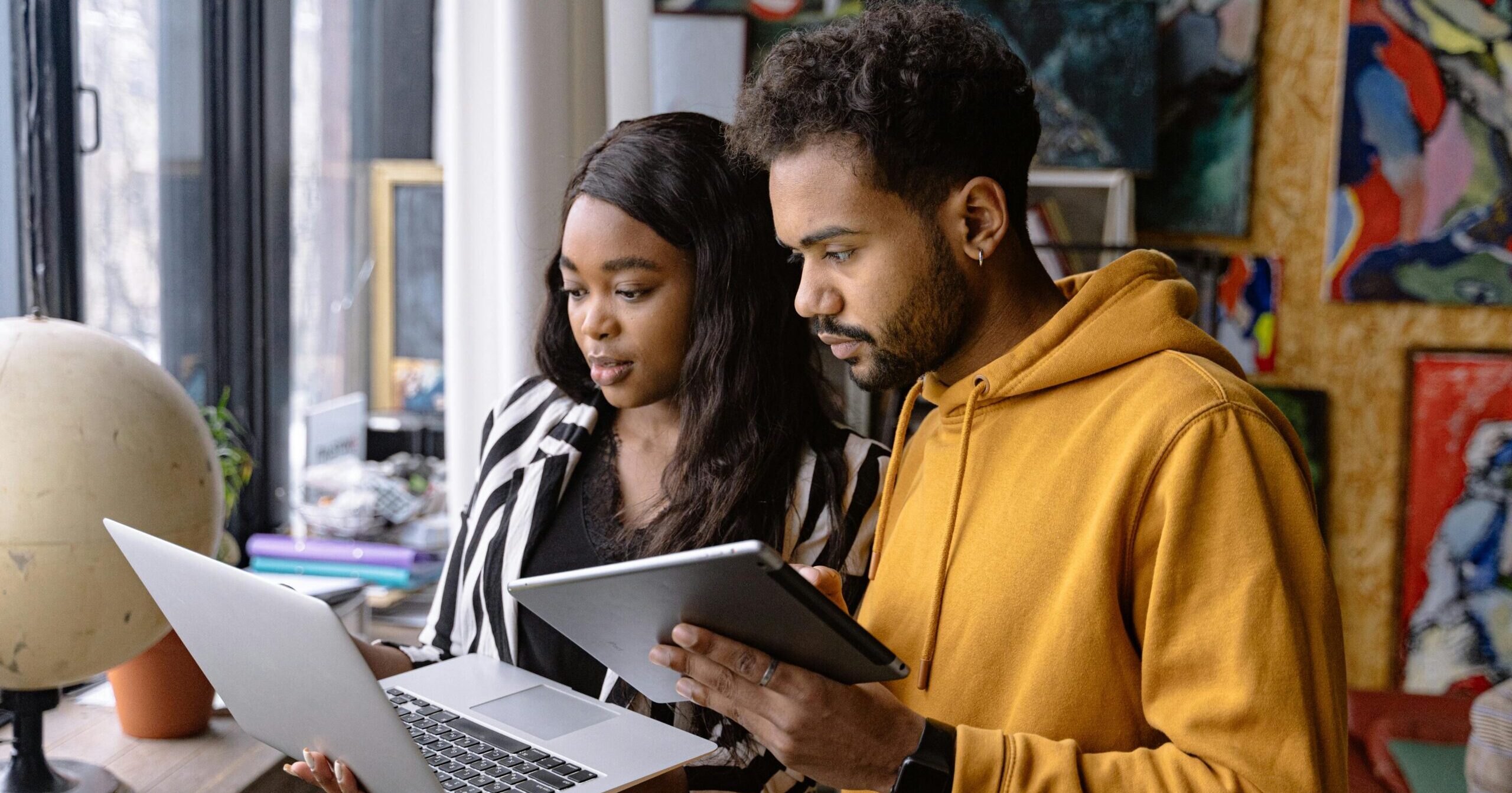 Two coworkers comparing financial close reports.