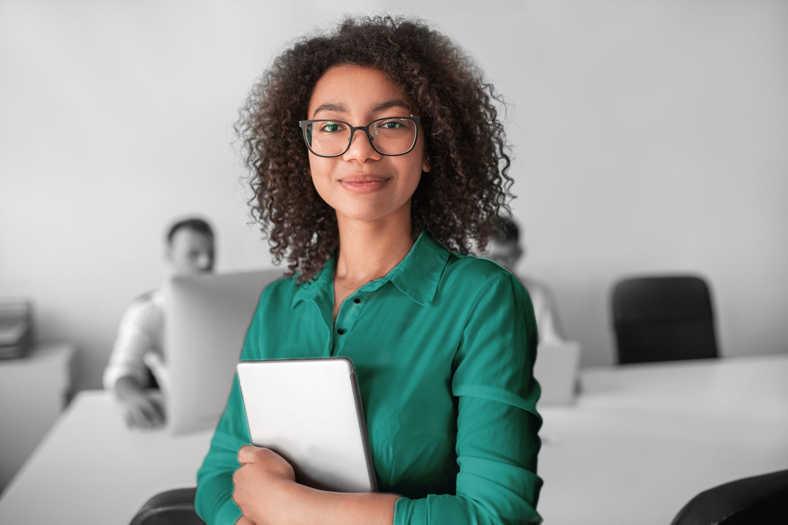 Woman wearing glasses holding a tablet