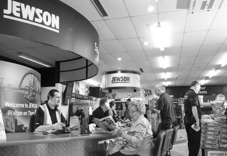 Jewson | Image of people in a common area with Jewson logo and signage.