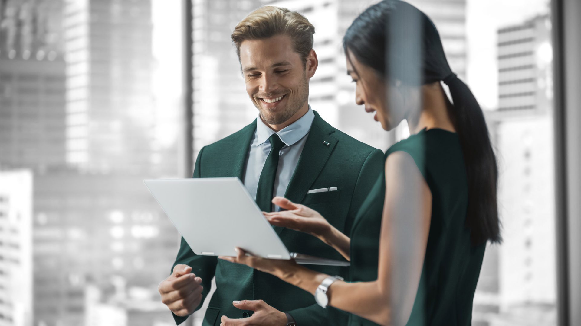 Image of CIO and Technology meeting talking over a laptop