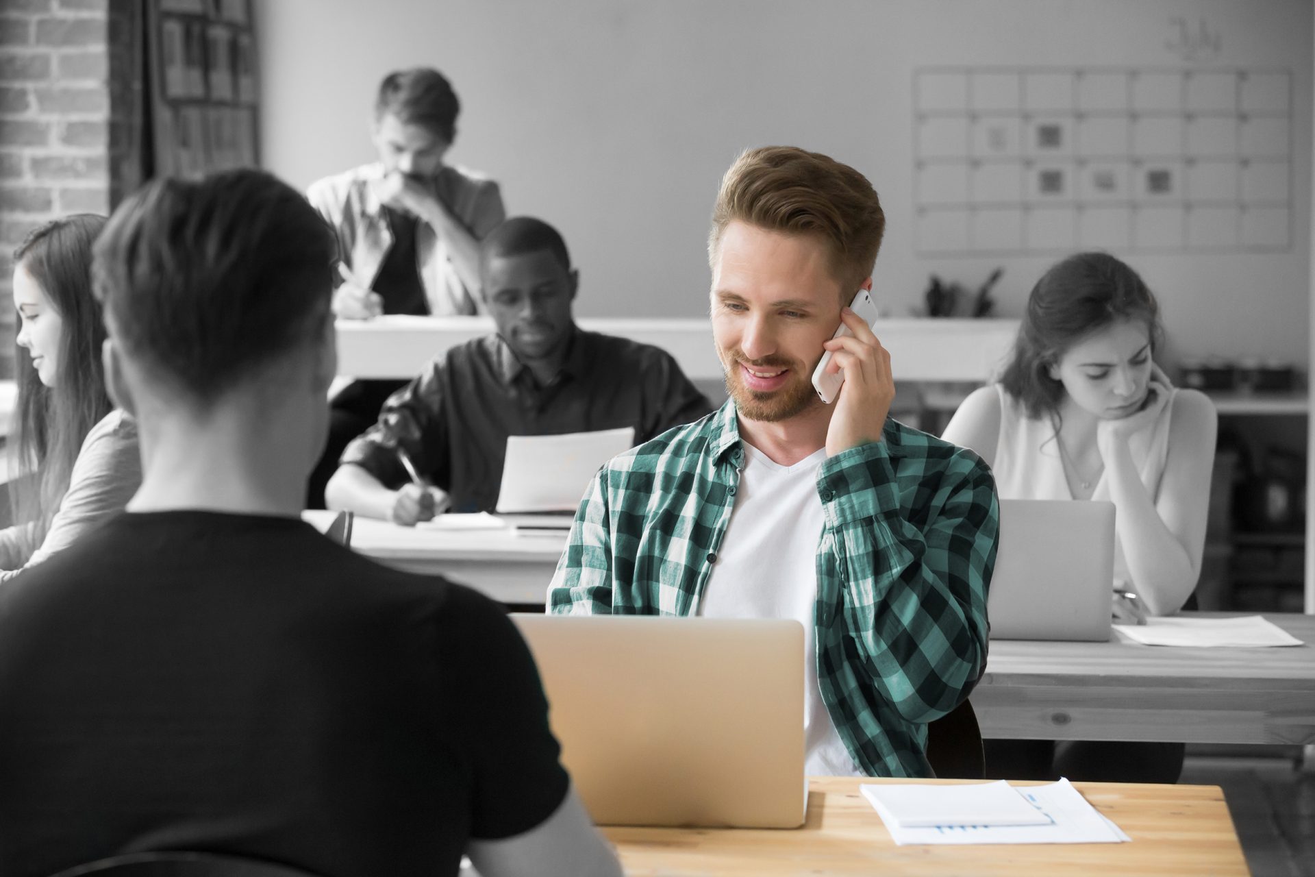 Man in shared service center on a phone call