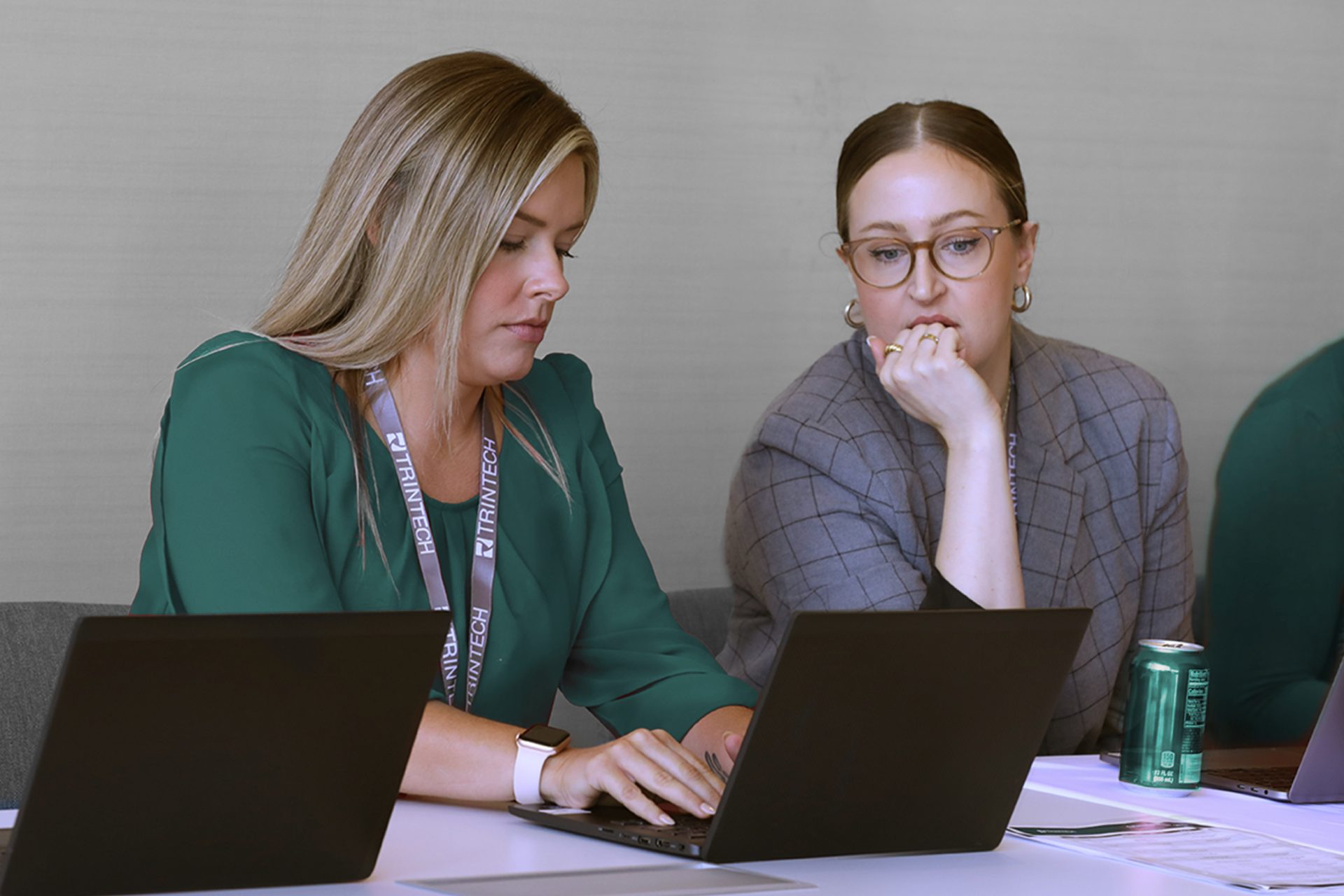Trintech staff working at their desk on laptops