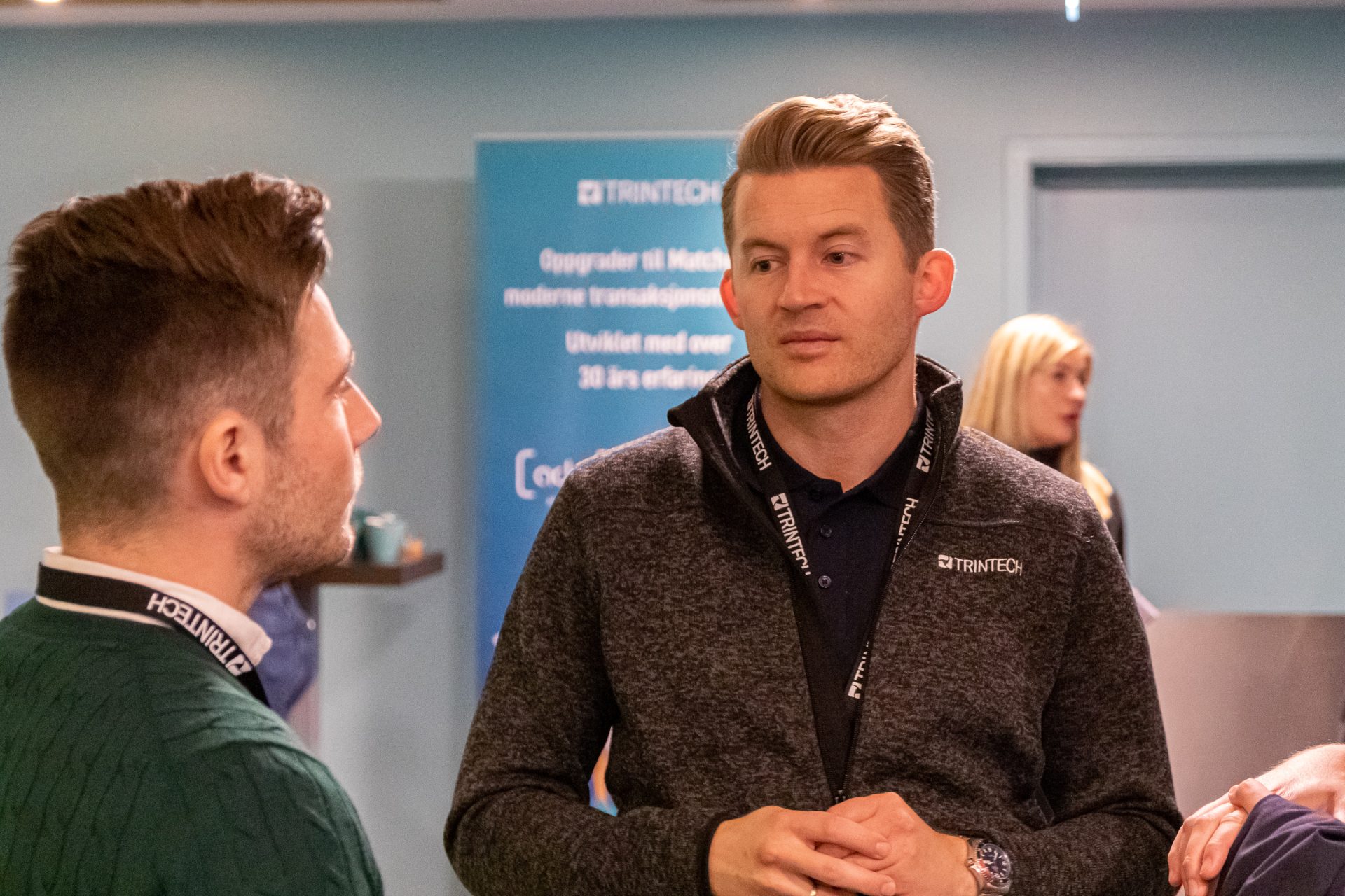 Trintech partner team at an event talking to customers