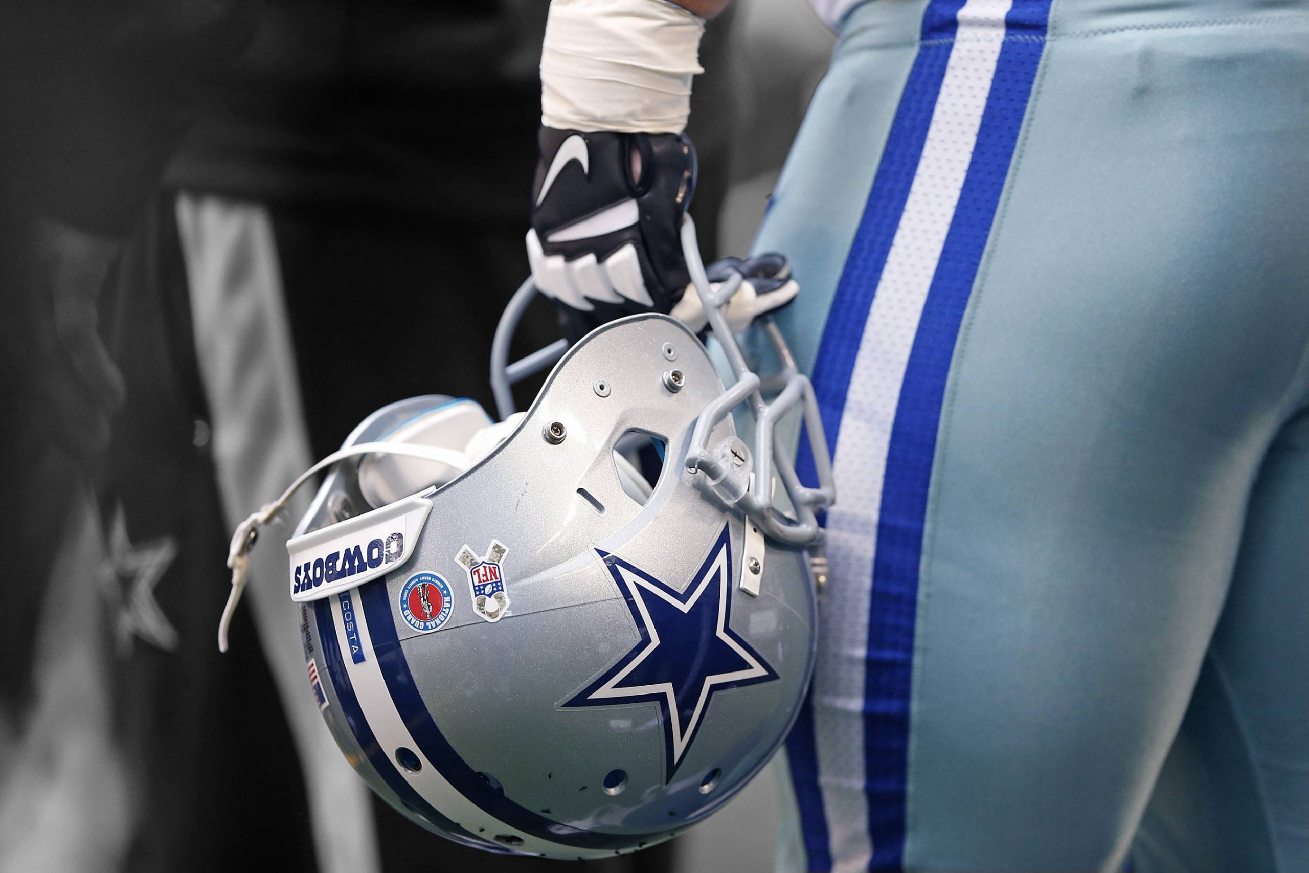 Dallas Cowboys Helmet held in hand by a player