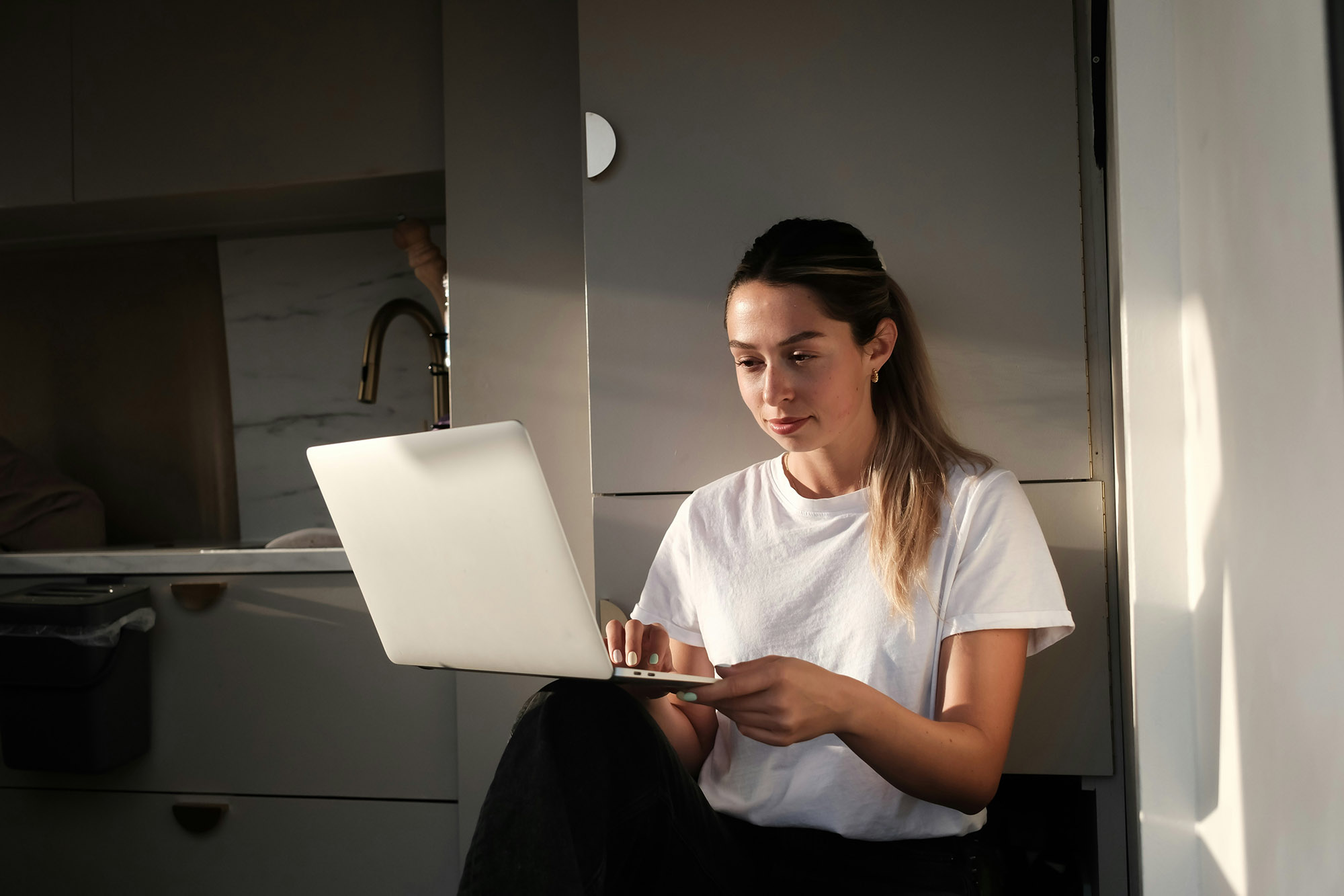 Professional working on journal entry accounting and account reconciliation tasks from laptop at home