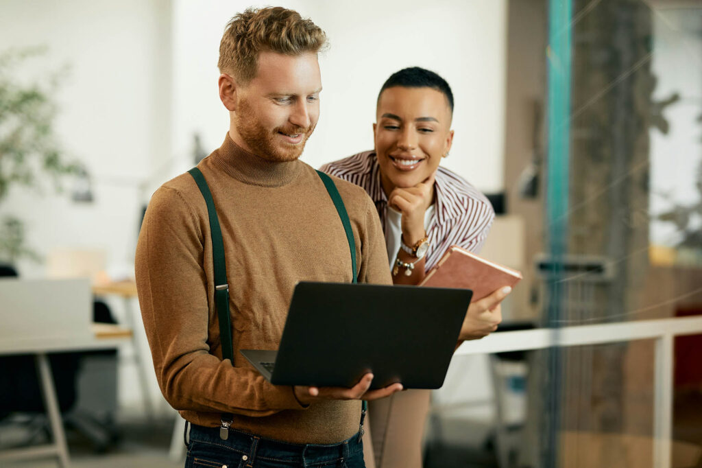 Young man and woman looking at a laptop